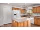 Bright kitchen features wood cabinets, white appliances, and kitchen island at 4121 W Paradise Dr, Phoenix, AZ 85029