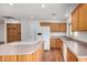 Spacious kitchen with wood cabinets, white appliances, and center island at 4121 W Paradise Dr, Phoenix, AZ 85029