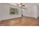 Bright living room features attractive flooring, a ceiling fan, and natural light at 4121 W Paradise Dr, Phoenix, AZ 85029