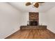 Living room featuring wood-look flooring and red brick fireplace at 4121 W Paradise Dr, Phoenix, AZ 85029