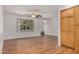 Living room featuring wood-look floors, bright window and built in cabinets at 4121 W Paradise Dr, Phoenix, AZ 85029