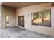 Covered back patio features concrete floors and a door to the interior at 418 E Clairidge Dr, San Tan Valley, AZ 85143