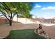 Spacious backyard with desert landscaping and artificial turf area at 418 E Clairidge Dr, San Tan Valley, AZ 85143