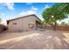 Backyard with desert landscaping, a small patch of artificial turf, and mature trees at 418 E Clairidge Dr, San Tan Valley, AZ 85143
