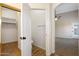 Bathroom with adjacent walk-in closet, toilet room and archway to bedroom at 418 E Clairidge Dr, San Tan Valley, AZ 85143