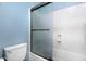 Bathroom featuring a toilet, tiled shower and blue walls at 418 E Clairidge Dr, San Tan Valley, AZ 85143