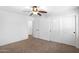 This bright bedroom features carpet, a ceiling fan, and a closet for ample storage at 418 E Clairidge Dr, San Tan Valley, AZ 85143