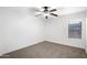 This bright bedroom features carpet and a ceiling fan at 418 E Clairidge Dr, San Tan Valley, AZ 85143