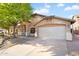 Well-maintained single-story home featuring a two-car garage and desert landscaping at 418 E Clairidge Dr, San Tan Valley, AZ 85143