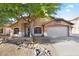 Inviting home featuring desert landscaping, mature tree, and a well-kept lawn at 418 E Clairidge Dr, San Tan Valley, AZ 85143