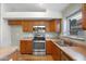 Kitchen features stainless-steel appliances, tile floors and plenty of storage at 418 E Clairidge Dr, San Tan Valley, AZ 85143