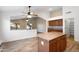 Kitchen features an island with a breakfast bar and tile floors, and easy access to the living room at 418 E Clairidge Dr, San Tan Valley, AZ 85143