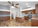 Kitchen features an island with a breakfast bar and stainless-steel appliances and tile floors at 418 E Clairidge Dr, San Tan Valley, AZ 85143