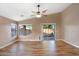 Bright living room featuring wood floors, a modern ceiling fan, and sliding glass doors to the backyard at 418 E Clairidge Dr, San Tan Valley, AZ 85143