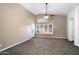 Bright living room with vaulted ceilings, ample windows, neutral carpet, and access to the patio at 418 E Clairidge Dr, San Tan Valley, AZ 85143