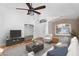 Staged living room with ceiling fan, wood-look floors, and a neutral color palette at 418 E Clairidge Dr, San Tan Valley, AZ 85143