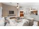 Staged living area with wood-look floors seamlessly transitioning into the kitchen at 418 E Clairidge Dr, San Tan Valley, AZ 85143