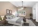 Staged main bedroom with vaulted ceiling, ceiling fan, lots of natural light and neutral carpet at 418 E Clairidge Dr, San Tan Valley, AZ 85143