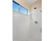 Shower with a large window, a shower head, and a built-in soap holder at 418 E Clairidge Dr, San Tan Valley, AZ 85143
