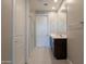 Modern bathroom featuring dual sinks, wood cabinets, tiled floors, and walk-in shower at 4215 W Suncup Dr, San Tan Valley, AZ 85144