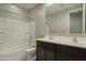 A full bathroom with a double sink vanity, large mirror, and shower-tub combo at 4215 W Suncup Dr, San Tan Valley, AZ 85144