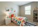 Bright bedroom with playful decor, colorful bedding, and ample natural light at 4215 W Suncup Dr, San Tan Valley, AZ 85144