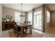 Cozy dining room with a wooden table, chandelier, and sliding glass doors at 4215 W Suncup Dr, San Tan Valley, AZ 85144