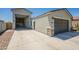 Exterior of house features a spacious driveway with an extra detached garage and gray stone accents at 4215 W Suncup Dr, San Tan Valley, AZ 85144