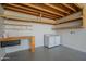 Garage featuring a work bench, plenty of built in shelving and a washer and dryer at 4215 W Suncup Dr, San Tan Valley, AZ 85144