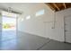 Bright garage with white walls, windows, and an automatic door opener at 4215 W Suncup Dr, San Tan Valley, AZ 85144