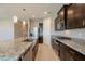 A kitchen view featuring a stainless steel fridge and a large island with a granite countertop at 4215 W Suncup Dr, San Tan Valley, AZ 85144