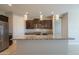 An open concept kitchen featuring stainless steel appliances, granite countertop, and modern hanging lights at 4215 W Suncup Dr, San Tan Valley, AZ 85144