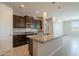 Kitchen area showcasing granite countertops, modern light fixtures and stainless appliances at 4215 W Suncup Dr, San Tan Valley, AZ 85144