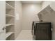 Well-organized laundry room with built-in shelving and a modern washer and dryer at 4215 W Suncup Dr, San Tan Valley, AZ 85144