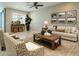 This is a spacious living room with neutral walls, a ceiling fan, and comfortable seating at 4215 W Suncup Dr, San Tan Valley, AZ 85144