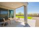 Covered patio featuring modern patio furniture and desert landscaping at 4215 W Suncup Dr, San Tan Valley, AZ 85144