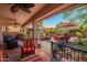 Inviting covered back patio with comfortable seating and a view of the beautifully landscaped backyard at 44041 W Bailey Dr, Maricopa, AZ 85138