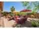 Well-designed backyard patio featuring multiple seating areas and vibrant landscaping, great for outdoor enjoyment at 44041 W Bailey Dr, Maricopa, AZ 85138