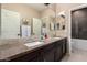 Bathroom featuring double sinks with granite countertops and a tub with a shower at 44041 W Bailey Dr, Maricopa, AZ 85138