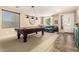 Game room with a pool table, natural light, and views into the living room at 44041 W Bailey Dr, Maricopa, AZ 85138