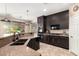 Beautiful kitchen featuring dark cabinets, sleek appliances, and light countertops at 44041 W Bailey Dr, Maricopa, AZ 85138