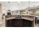Modern kitchen boasts granite countertops, stainless steel appliances and stylish pendant lighting at 44041 W Bailey Dr, Maricopa, AZ 85138