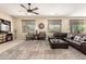 Cozy living room with a ceiling fan, plush seating, and a large area rug at 44041 W Bailey Dr, Maricopa, AZ 85138