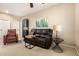 Well lit living room offers comfortable seating arrangements, a ceiling fan and a side table at 44041 W Bailey Dr, Maricopa, AZ 85138