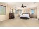 Inviting main bedroom with a fireplace, neutral tones, and ample natural light at 44041 W Bailey Dr, Maricopa, AZ 85138
