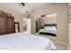 Bedroom with an accent mirror and a comfortable queen size bed at 44041 W Bailey Dr, Maricopa, AZ 85138
