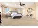 Spacious main bedroom features a comfortable bed, neutral decor, and a ceiling fan at 44041 W Bailey Dr, Maricopa, AZ 85138