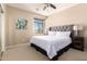 Bedroom with a large bed, nightstands, and a window with natural lighting at 44041 W Bailey Dr, Maricopa, AZ 85138