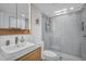 This bright bathroom features a walk-in shower, modern vanity, and a mirror with decorative lighting at 4411 N 40Th St # 59, Phoenix, AZ 85018