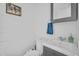 Cozy bathroom with white brick walls featuring a sink, toilet, and a framed art piece at 4411 N 40Th St # 59, Phoenix, AZ 85018